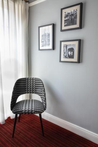 a chair in a room with two pictures on the wall at No 9 Springfield in Sydney