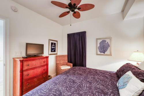 a bedroom with a bed and a tv and a dresser at Sterling Shores 205 in Destin