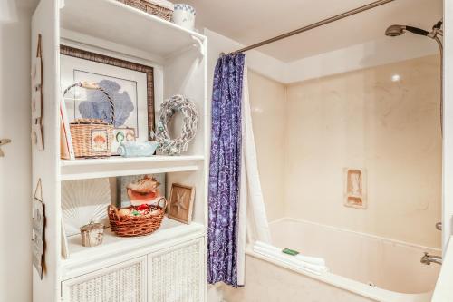 a bathroom with a shower and a white cabinet at Sterling Shores 205 in Destin