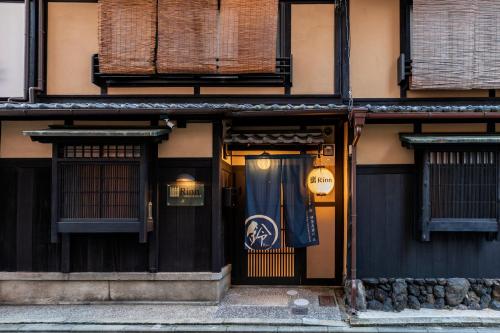 a building with a door with a sign on it at Rinn Shijo Takase River North in Kyoto