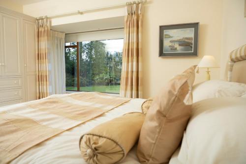a bedroom with a large bed and a window at Inḃear Scéine in Kenmare