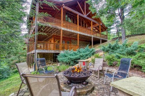 a fire pit in front of a log cabin at Mountain Jewel, Game Room , Fire Pit, Theater Area, WIFI, Pool access!!! in Gatlinburg