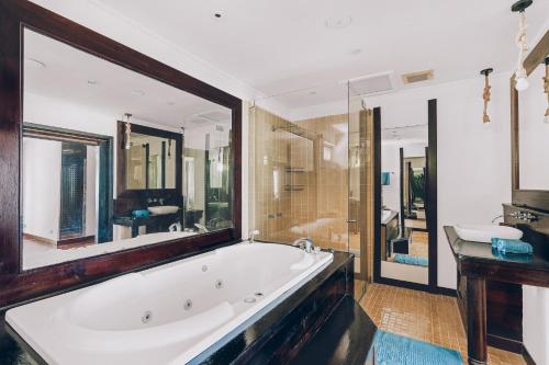 a large bathroom with a tub and a shower at Samui Art Villa in Bophut