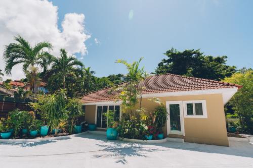 a small house with a lot of plants in front of it at Beachfront Art Villa Samui in Bophut 