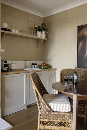 a kitchen with a table and two chairs and a counter at Verandah House Country Estate in Mount Tamborine