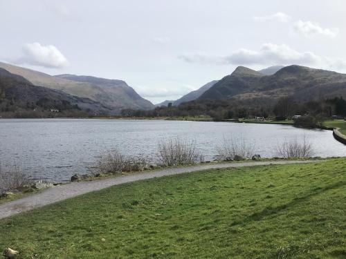 a view of a lake with mountains in the background at Llanberis Lodges in Llanberis