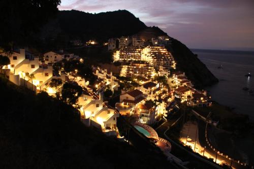 a town on the side of a hill at night at Modern Hamilton Cove Villa w/golf cart in Avalon