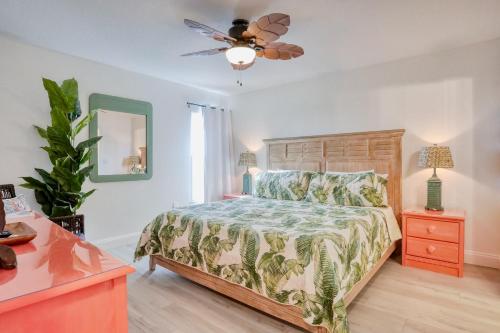 a bedroom with a bed and a ceiling fan at Beach on the Rocks in Clearwater Beach