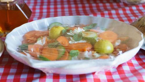 a bowl of food with carrots and other vegetables at wahiba Bedouiens privae Camp in Muntarib