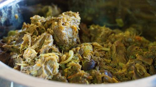 a bowl of food with meat and other ingredients at wahiba Bedouiens privae Camp in Muntarib