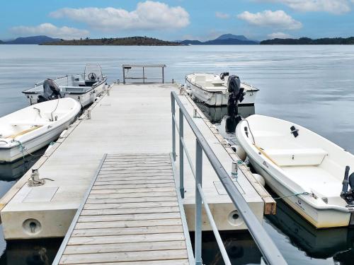 two boats are docked at a dock in the water at 6 person holiday home in Onarheim in Onarheim