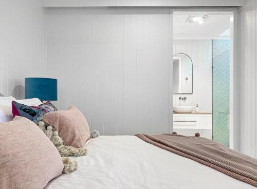 a bedroom with a bed with a sink and a mirror at Lusso Retreats in Moffatdale