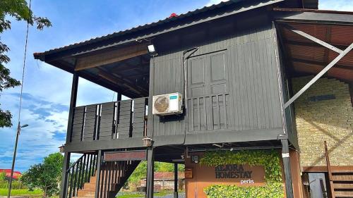 a building with a door on the side of it at Kejora Homestay in Kangar