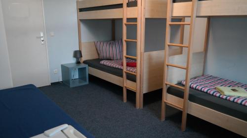 a bunk bed room with two bunk beds and a chair at Hostel Inn-Berlin in Berlin