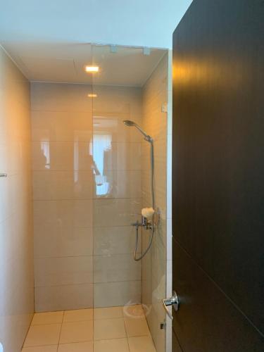 a bathroom with a shower with a glass door at Le Maisse Executive Studio 1BR opp Okada in Manila