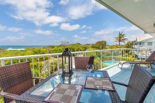 a balcony with a table and chairs and the ocean at 12 60 Peregian Esplanade Peregian Beach in Peregian Beach