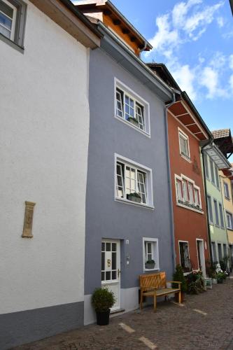 a blue and white building with a bench in front of it at Charmantes Stadthaus in Waldshut-Tiengen