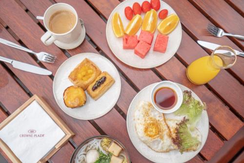 a table with plates of food and cups of coffee at Crowne Plaza Quanzhou Riverview by IHG in Quanzhou