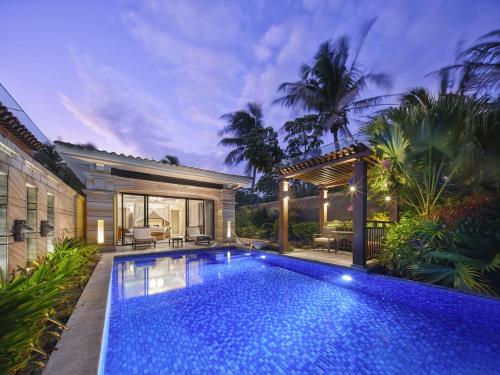 a swimming pool in the backyard of a house at Wanda Reign Resort & Villas Sanya Haitang Bay in Sanya