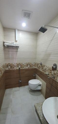 a bathroom with a toilet and a sink at Annapurna Hotel in Bīrganj