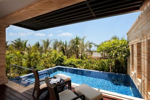 a view from the balcony of a villa with a swimming pool at Wanda Reign Resort & Villas Sanya Haitang Bay in Sanya