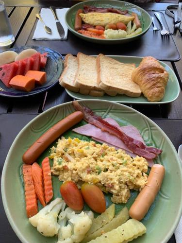 a table topped with plates of food with different types of food at Sukantara Cascade Resort and Spa in Mae Rim