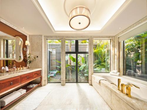 a bathroom with a tub and a large window at Wanda Reign Resort & Villas Sanya Haitang Bay in Sanya