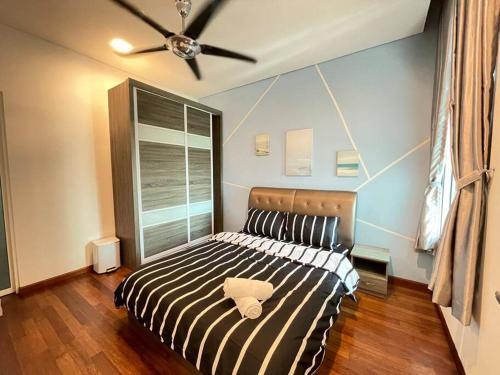 a bedroom with a bed with a ceiling fan at 1Medini 1BedRoom NiceView By WP Homestay in Johor Bahru