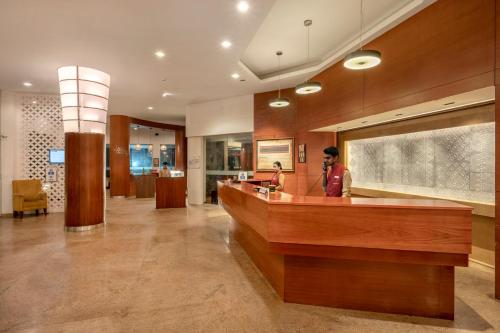 a lobby of a hotel with a reception desk at Sterling Ooty Fern Hill in Ooty