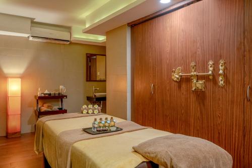 a hospital room with a bed with a cross on the wall at Sterling Ooty Fern Hill in Ooty