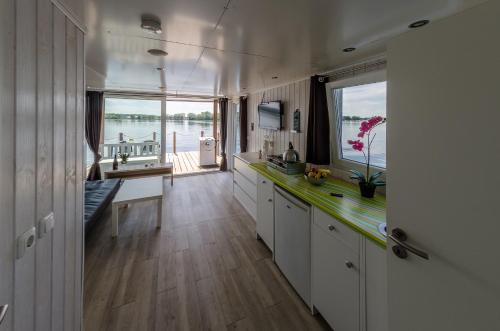 a large kitchen with a view of the water at feststehendes Hausboot in Kolonie Zern