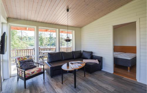 a living room with a couch and a table at Nice Home In Dals-Långed With Kitchen in Dals Långed