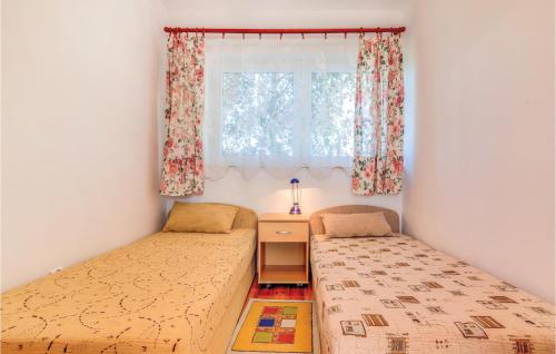 a bedroom with two beds and a window at Cozy Apartment In Rowy With Kitchen in Rowy
