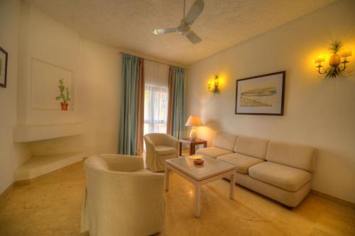 a living room with a couch and a table at Hotel Ta' Cenc & Spa in Sannat