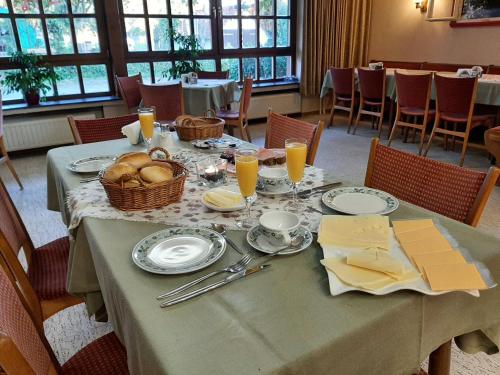 a table with food and a basket of bread on it at Gasthaus Pension Schumbert in Bullau