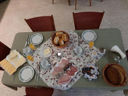 a green table with a plate of food on it at Gasthaus Pension Schumbert in Bullau