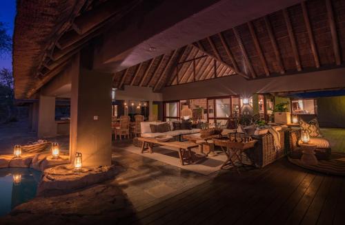 a patio of a villa with a table and chairs at Simbavati River Sands in Timbavati Game Reserve