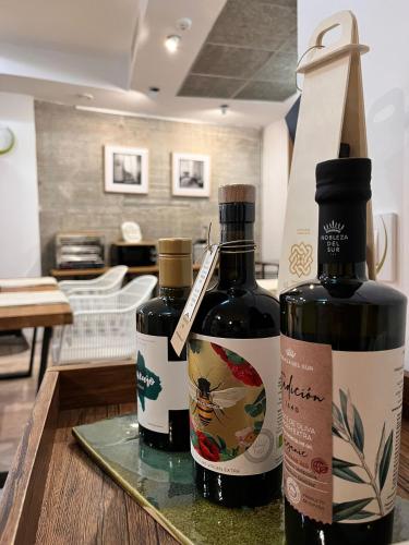 three bottles of wine sitting on a table at Hostal Casa de Luna y Sol in Úbeda