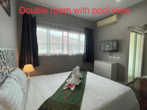 a bedroom with a bed with a room with pool view at Thalassa Kata Beach in Kata Beach