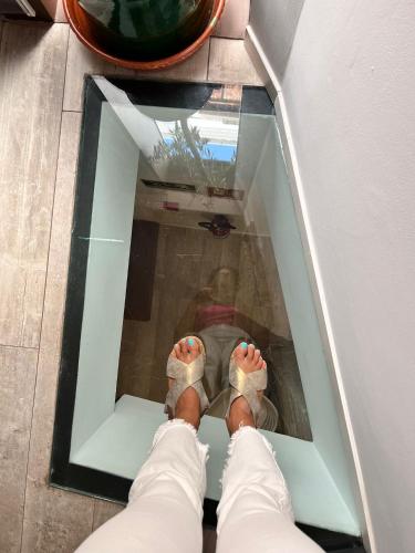 a person with their feet up in a glass window at Hostal Casa de Luna y Sol in Úbeda