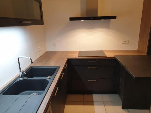 a kitchen with a sink and a counter top at Grande maison avec 5 chambres et jardin in Avignon