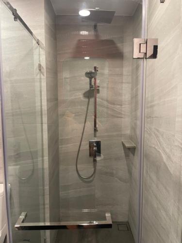 a shower with a glass door in a bathroom at The Edge central pattaya in Pattaya Central