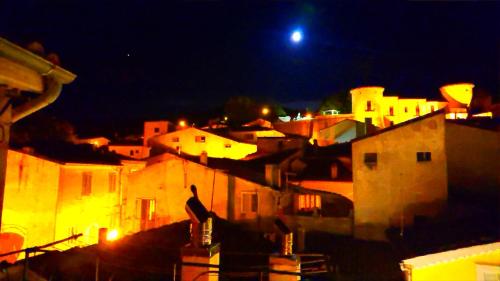 a view of a city at night with a moon at Casa Vacanze Piazza Apartment 2 in SantʼAndrea di Conza