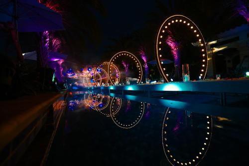 an amusement park at night with a ferris wheel at Wanda Reign Resort & Villas Sanya Haitang Bay in Sanya