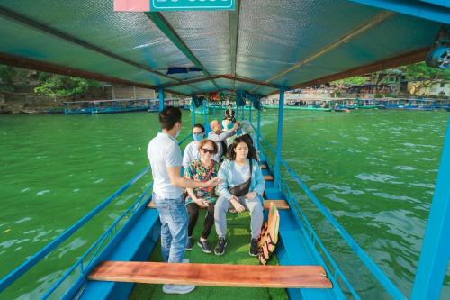 a group of people on a boat on the river at Ba Bể Green (View Ba Be lake) in Bak Kan