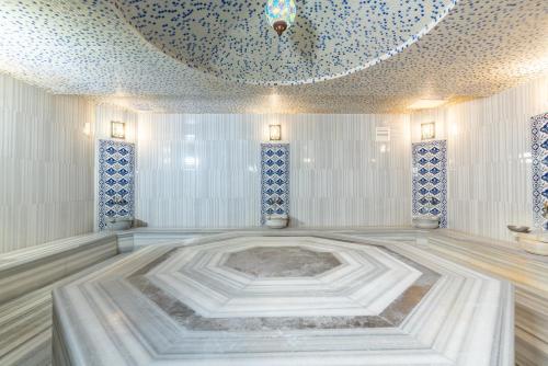 a room with a large tub in the middle of a room at City Live Hotel in Antalya