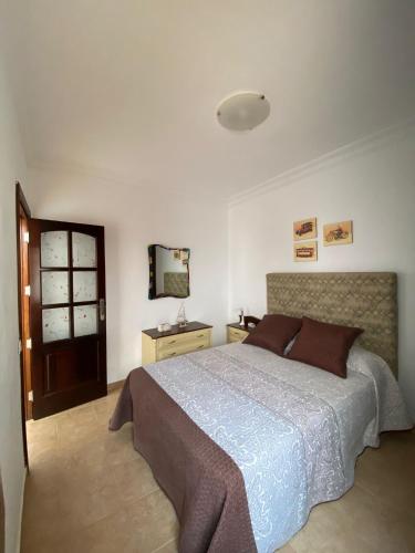 a bedroom with a large bed and a mirror at Casa Ale in Playa Quemada