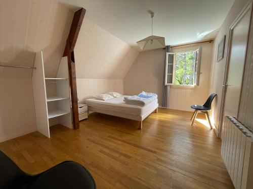 sypialnia z łóżkiem, drabiną i krzesłem w obiekcie Villa piscine 15 Personnes w mieście Brouchaud