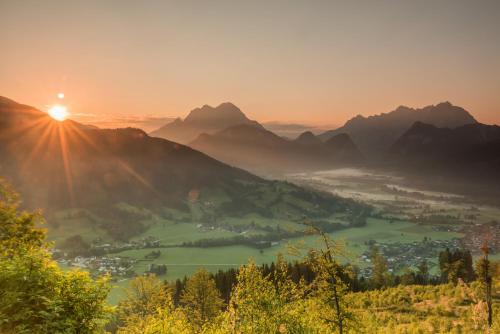 a view of a valley in the mountains at sunset at Xeis NeSt in Admont