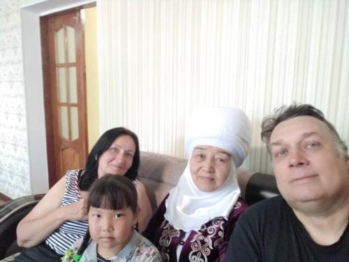a group of people sitting on a couch at Guest House Oimo in Balykchy